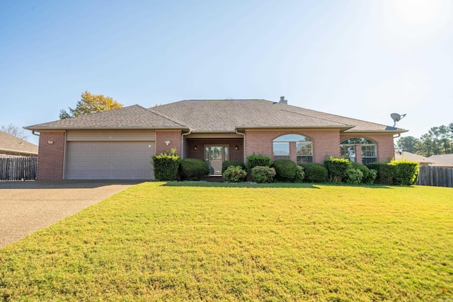 single story home with a garage and a front lawn