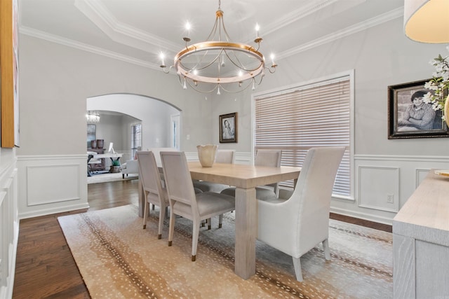 dining space with a tray ceiling, crown molding, dark hardwood / wood-style floors, and a chandelier