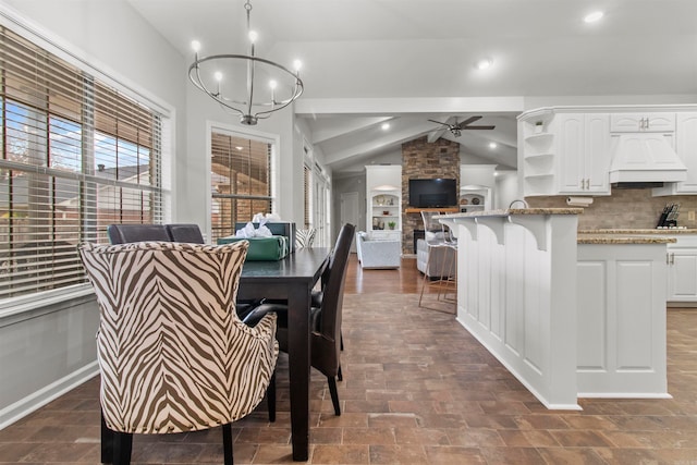 dining room featuring vaulted ceiling with beams and ceiling fan with notable chandelier