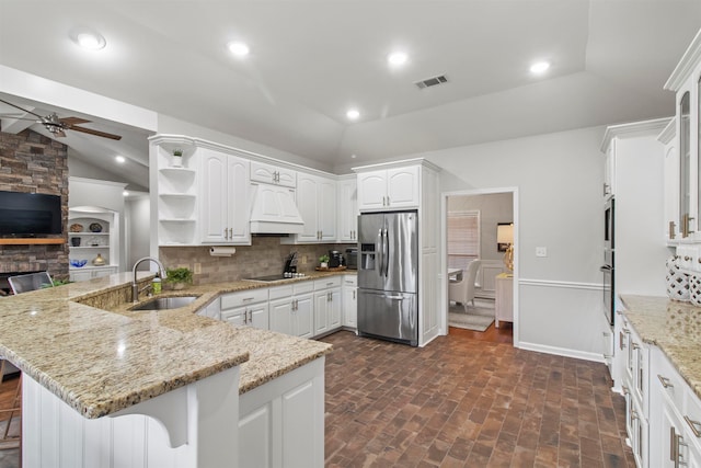 kitchen with stainless steel appliances, sink, kitchen peninsula, and white cabinets