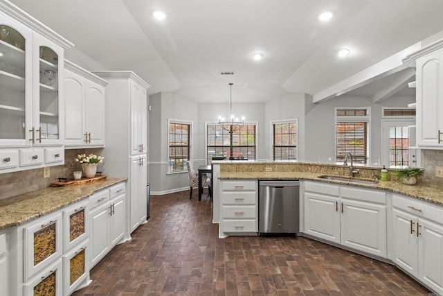 kitchen with sink, tasteful backsplash, dishwasher, and white cabinets