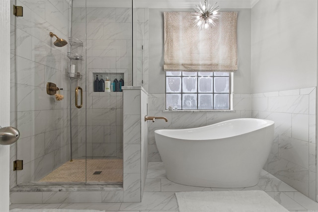 bathroom featuring tile walls and separate shower and tub