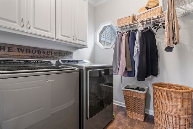 clothes washing area featuring cabinets, ornamental molding, and separate washer and dryer