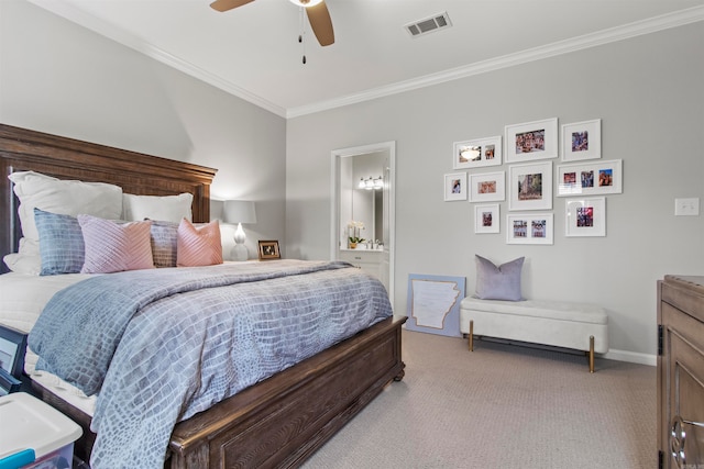 bedroom featuring crown molding, ensuite bath, light colored carpet, and ceiling fan