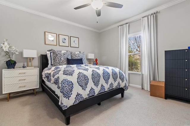 carpeted bedroom featuring crown molding and ceiling fan