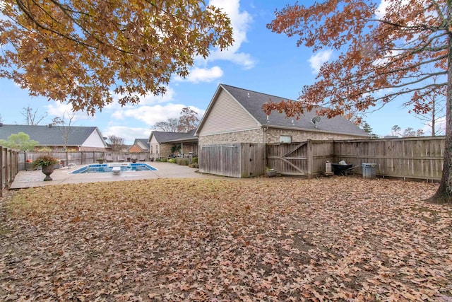 view of yard with a fenced in pool and a patio area