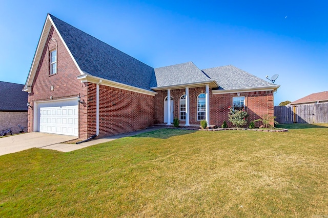 view of front of property with a garage and a front yard