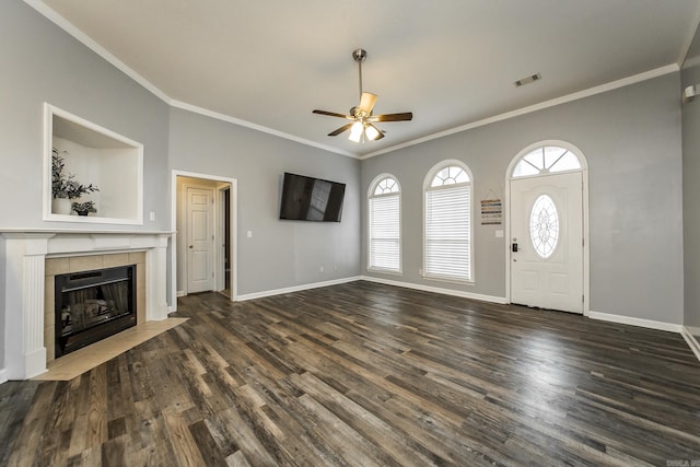18 Emma Dr, Cabot, AR 72023 - unfurnished living room with a ceiling fan, dark wood-style floors, ornamental molding, a tiled fireplace, and baseboards