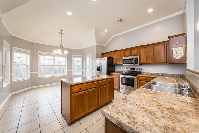 18 Emma Dr, Cabot, AR 72023 - kitchen with appliances with stainless steel finishes, a sink, vaulted ceiling, light tile patterned floors, and a chandelier