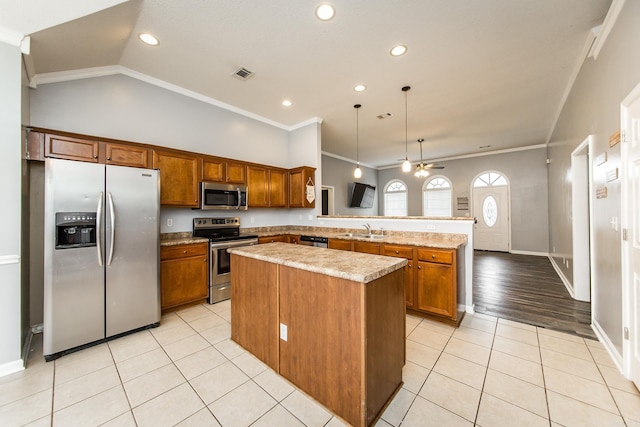 18 Emma Dr, Cabot, AR 72023 - kitchen featuring stainless steel appliances, a sink, a peninsula, brown cabinetry, and light tile patterned floors