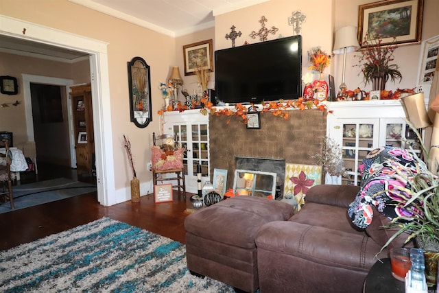 living room featuring crown molding and dark hardwood / wood-style flooring