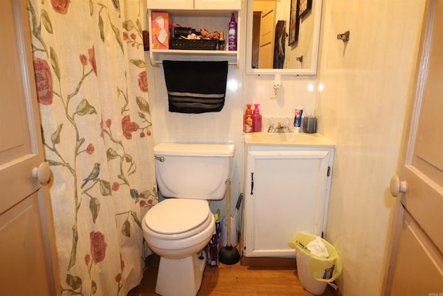 bathroom with hardwood / wood-style floors, vanity, toilet, and a shower with shower curtain