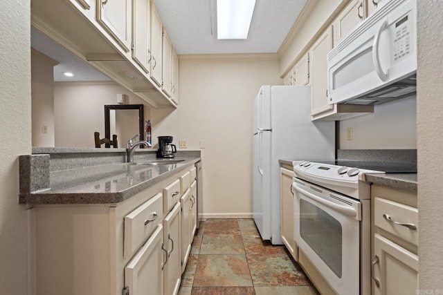 kitchen with white appliances, crown molding, and sink