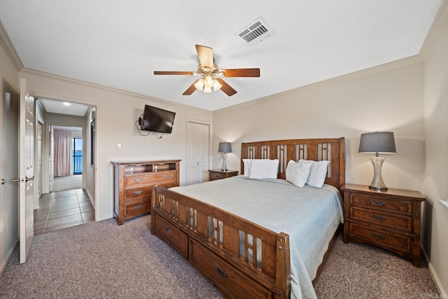 carpeted bedroom featuring a closet, a textured ceiling, crown molding, and ceiling fan