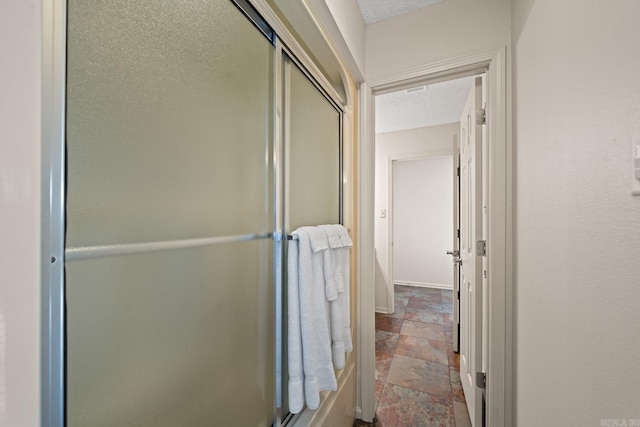 bathroom with a shower with shower door