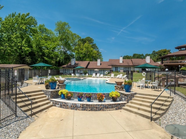 view of swimming pool with a gazebo and a patio area