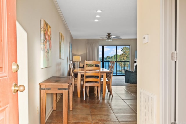 dining room with crown molding and ceiling fan