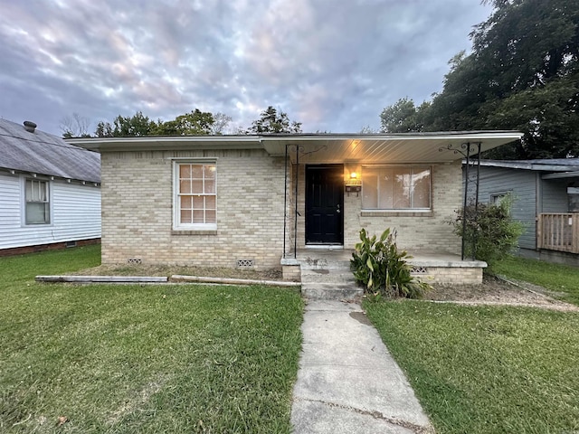 1817 W 16th St, North Little Rock, AR 72114 - view of front of property with a front lawn, brick siding, crawl space, and a porch