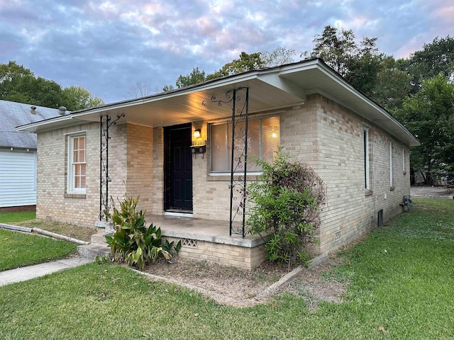 view of front of property with covered porch and a front yard