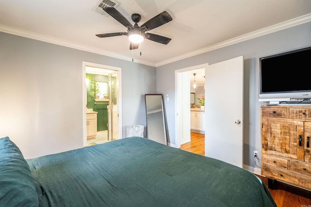 bedroom featuring ensuite bath, ornamental molding, light wood-type flooring, and ceiling fan