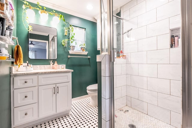 bathroom with toilet, a shower with shower door, vanity, crown molding, and tile patterned flooring