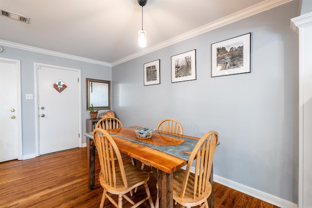 dining area featuring ornamental molding and wood-type flooring