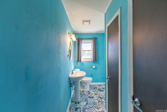 bathroom featuring toilet and tile patterned floors