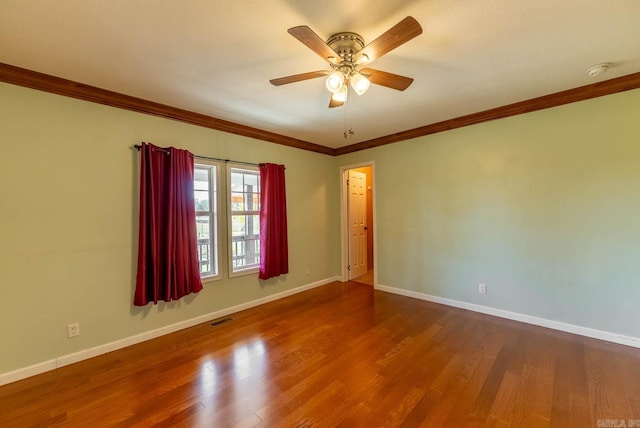 empty room with ornamental molding, hardwood / wood-style floors, and ceiling fan