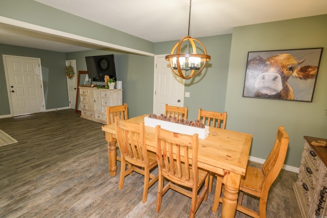 dining room with dark wood-type flooring and a chandelier