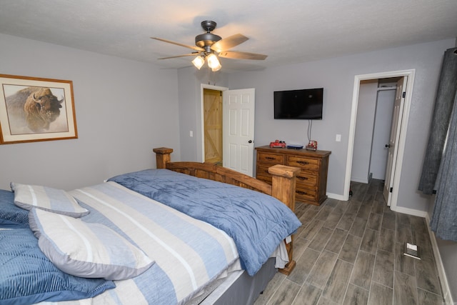 bedroom featuring dark hardwood / wood-style flooring, a textured ceiling, and ceiling fan