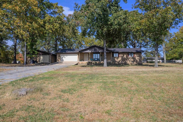 single story home with a front yard and a garage