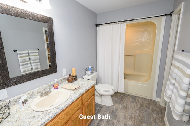 full bathroom featuring vanity, shower / bath combo, hardwood / wood-style flooring, and toilet