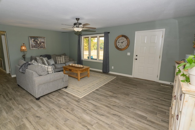 living room with hardwood / wood-style floors and ceiling fan