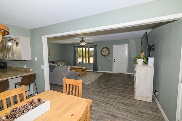 dining space featuring ceiling fan and dark hardwood / wood-style flooring