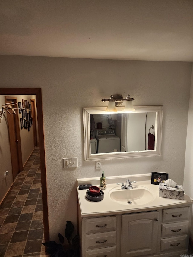 bathroom with vanity and washing machine and clothes dryer