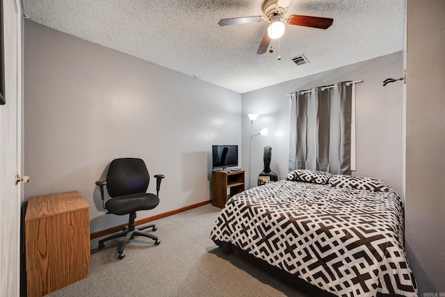 carpeted bedroom featuring a textured ceiling and ceiling fan