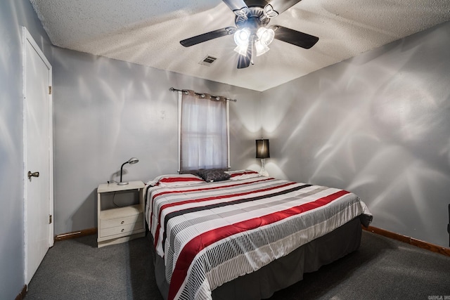 carpeted bedroom featuring ceiling fan and a textured ceiling