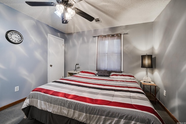 carpeted bedroom with a textured ceiling and ceiling fan