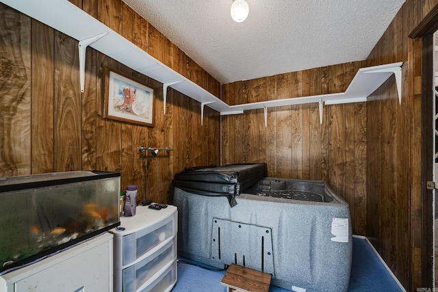 interior space with wood walls and a textured ceiling