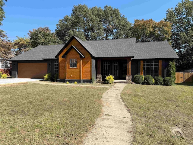 view of front of house with a front lawn and a garage