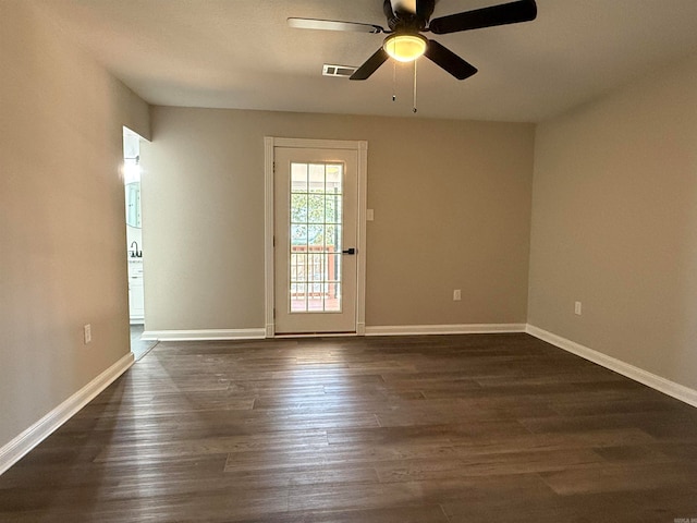 empty room with dark wood-type flooring and ceiling fan