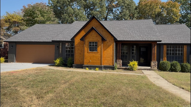 view of front of home featuring a front yard and a garage