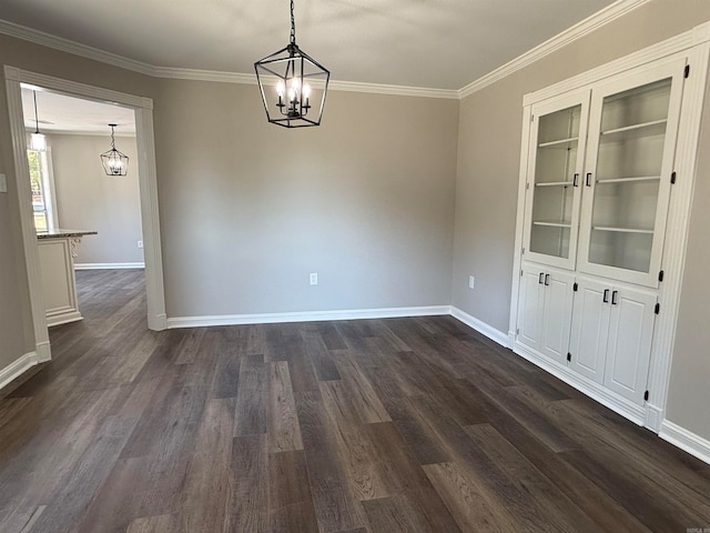 unfurnished dining area featuring ornamental molding, a notable chandelier, and dark hardwood / wood-style floors