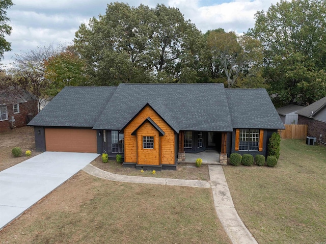 view of front of home with a garage and a front lawn