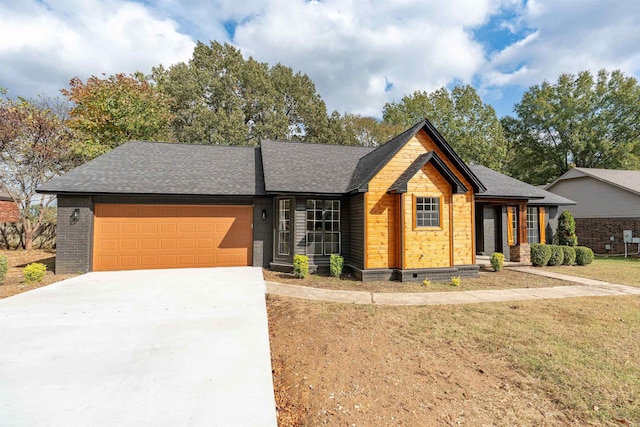 view of front facade with a front yard and a garage