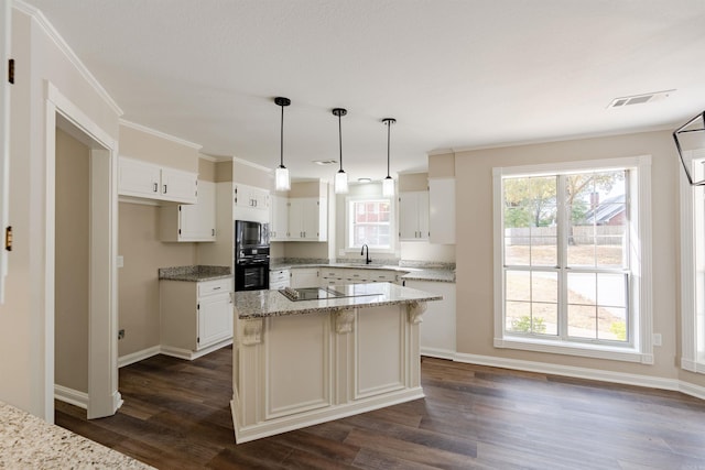 kitchen featuring white cabinetry, a healthy amount of sunlight, and a center island