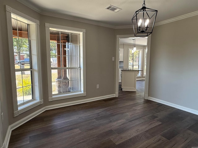 unfurnished dining area with an inviting chandelier, ornamental molding, a healthy amount of sunlight, and dark hardwood / wood-style flooring