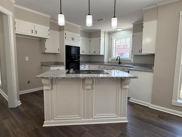 kitchen featuring black appliances, white cabinetry, dark wood-type flooring, and a center island