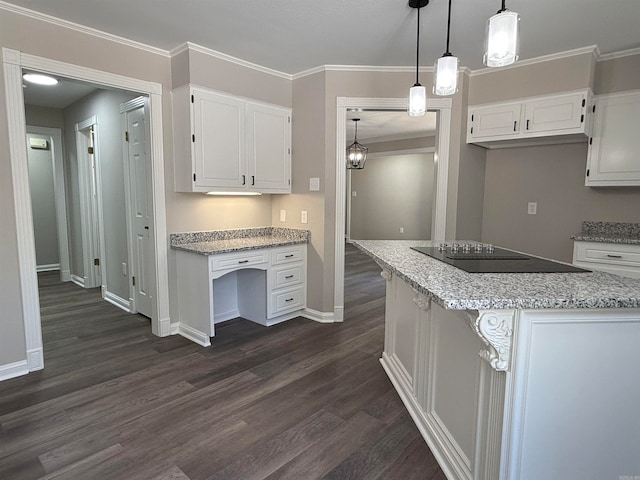 kitchen featuring white cabinets, hanging light fixtures, dark hardwood / wood-style floors, and black electric cooktop