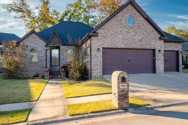 view of front of property with a front lawn and a garage